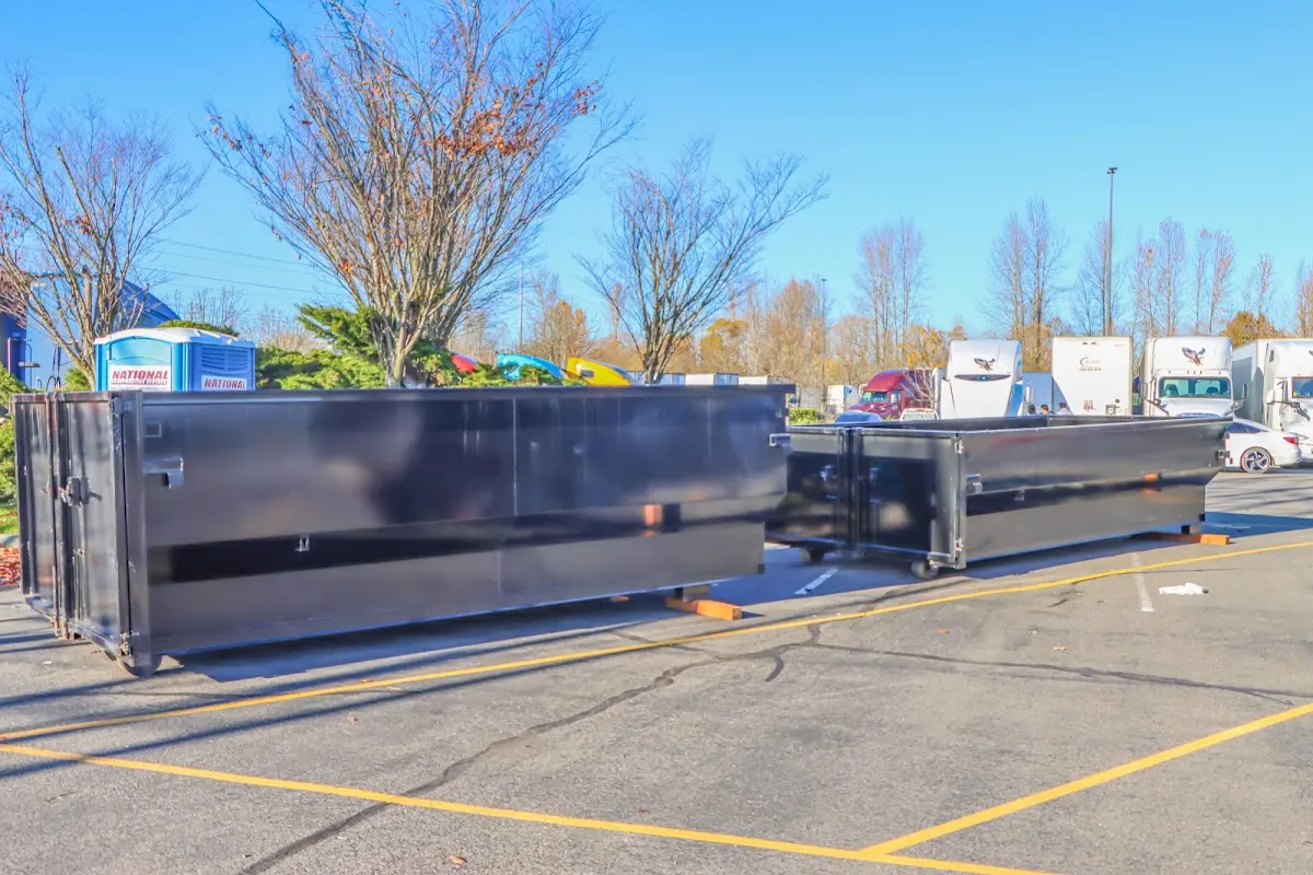 Professional dumpster rental service with roll-off container on residential driveway in Danvers